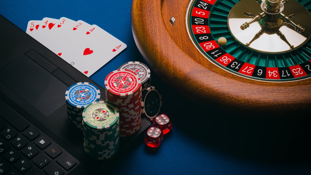 Laptop displaying online casino games with poker chips and dice